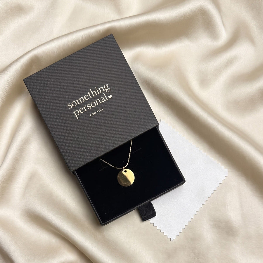 Something Personal gift box, opened to show the engraved pendant inside, ready to give